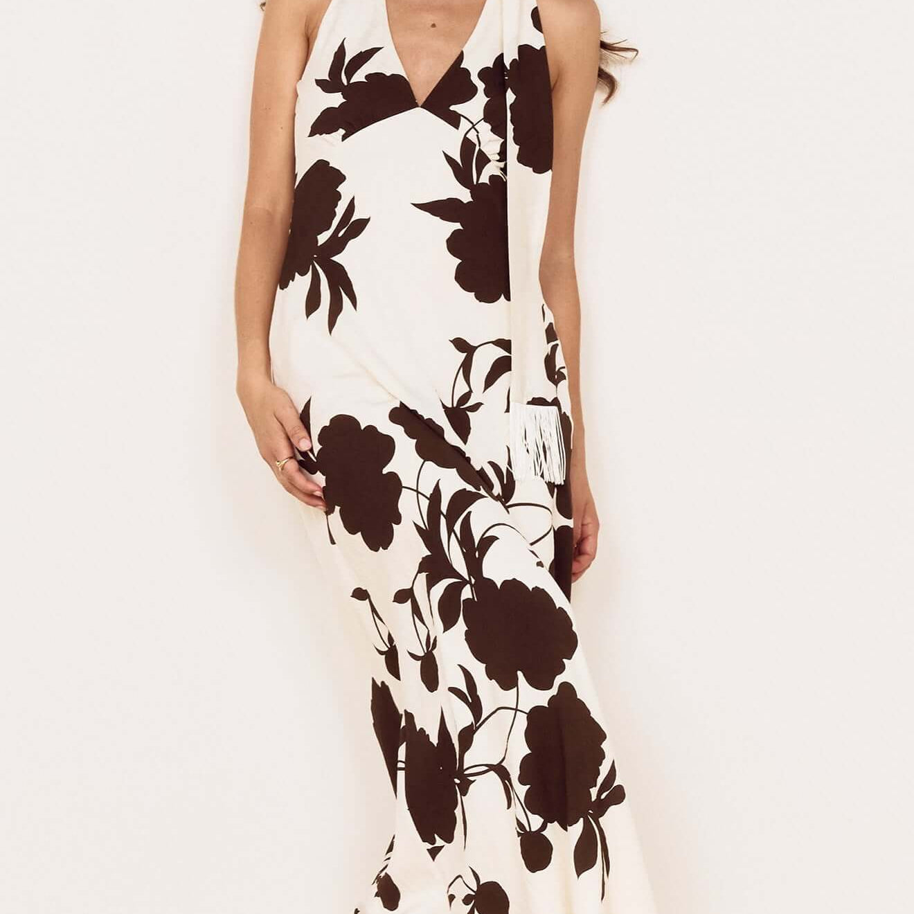 Brown and Cream Floral Halter Neck Maxi Dress on a model with a fringed neck scarf and oversized floral print.
