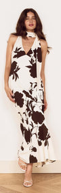 Brown and Cream Floral Halter Neck Maxi Dress on a model with a fringed neck scarf and oversized floral print.