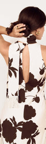 Back view of the Brown and Cream Floral Halter Neck Maxi Dress showcasing its elegant design and neck scarf.