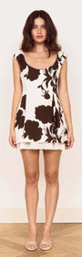 Model wearing a Brown and Cream Floral Layered Mini Dress with a soft scoop neckline and cap sleeves.