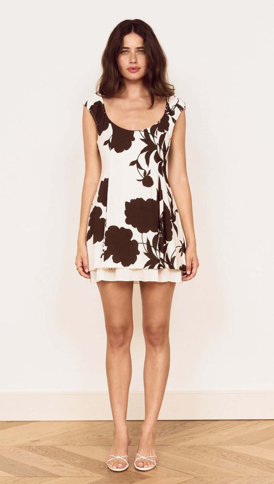 Model wearing a Brown and Cream Floral Layered Mini Dress with a soft scoop neckline and cap sleeves.