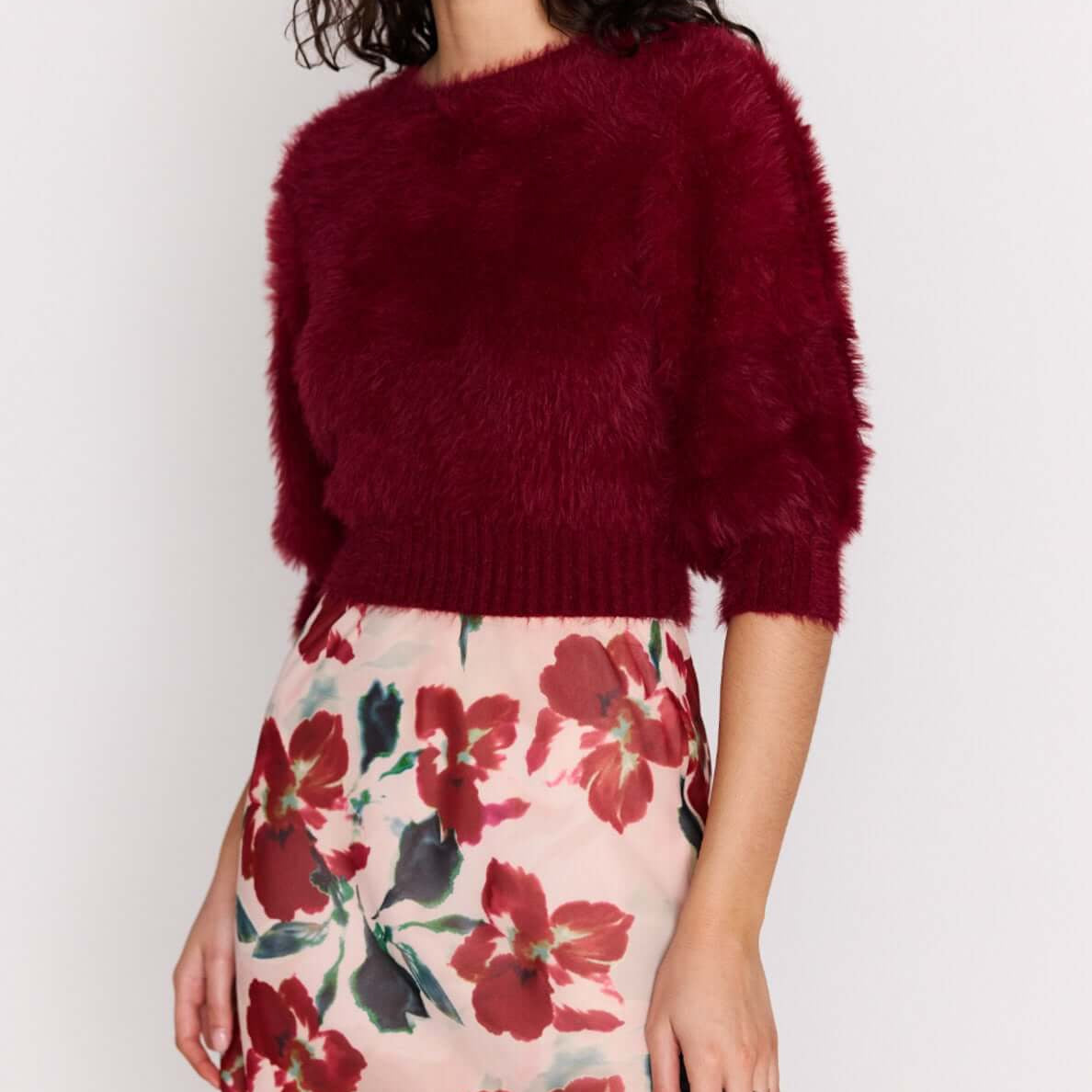 Burgundy Cropped Fluffy Knit Sweater paired with a floral skirt, showcasing a stylish and playful outfit.