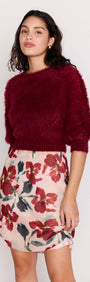 Burgundy Cropped Fluffy Knit Sweater paired with a floral skirt, showcasing a stylish and playful outfit.