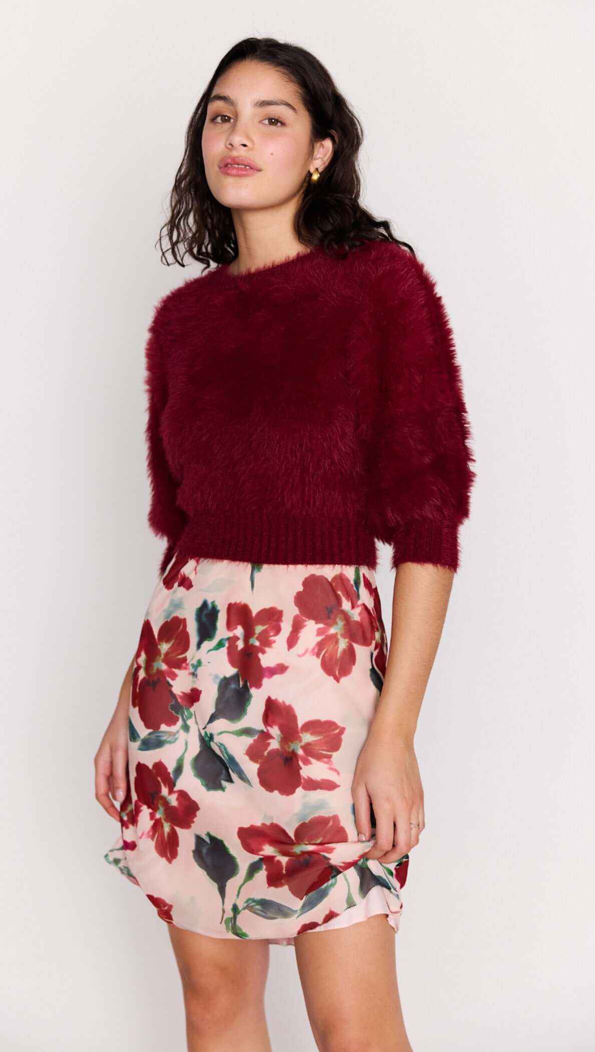 Burgundy Cropped Fluffy Knit Sweater paired with a floral skirt, showcasing a stylish and playful outfit.