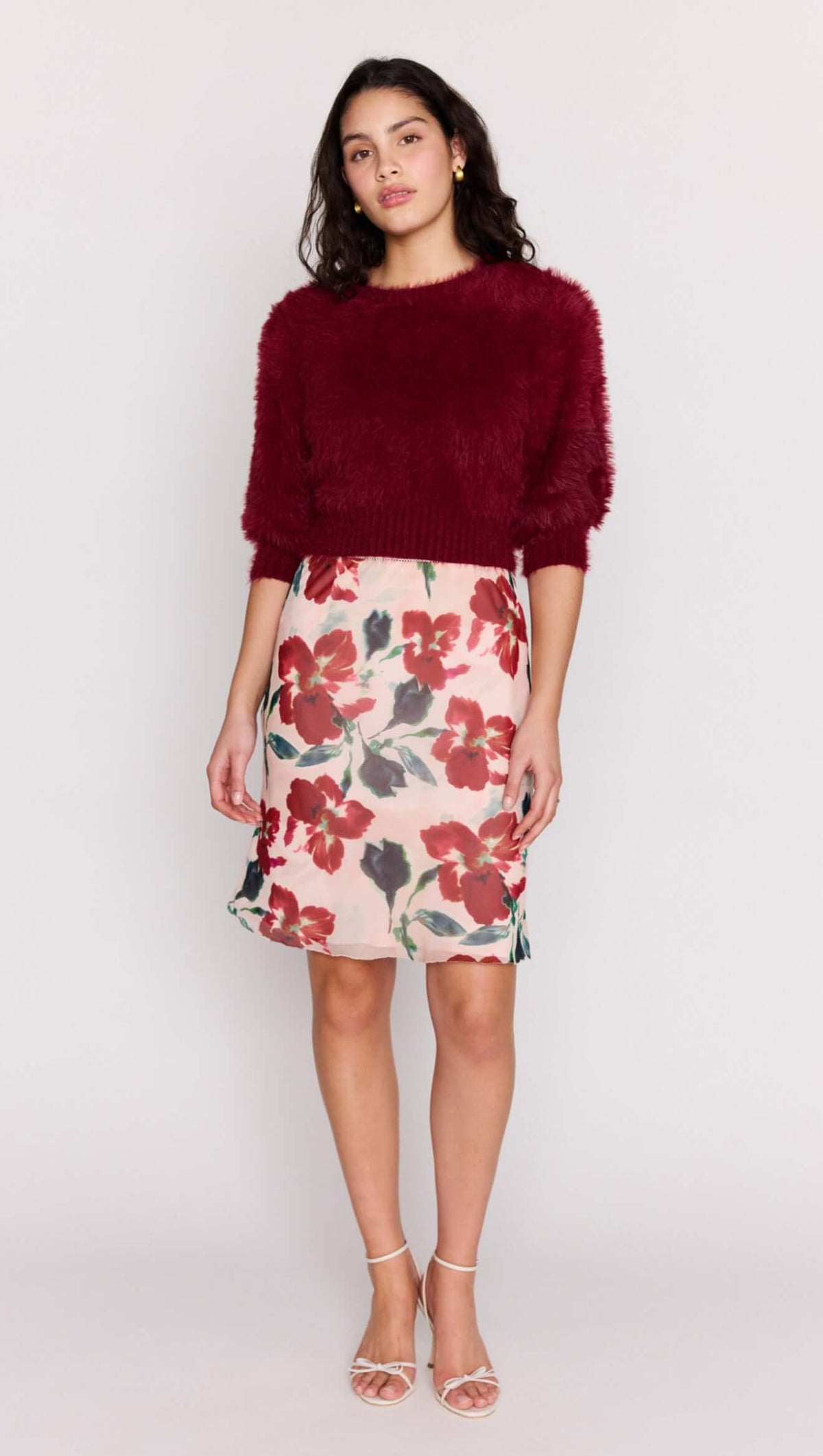 Model wearing a Burgundy Cropped Fluffy Knit Sweater styled with a floral skirt.