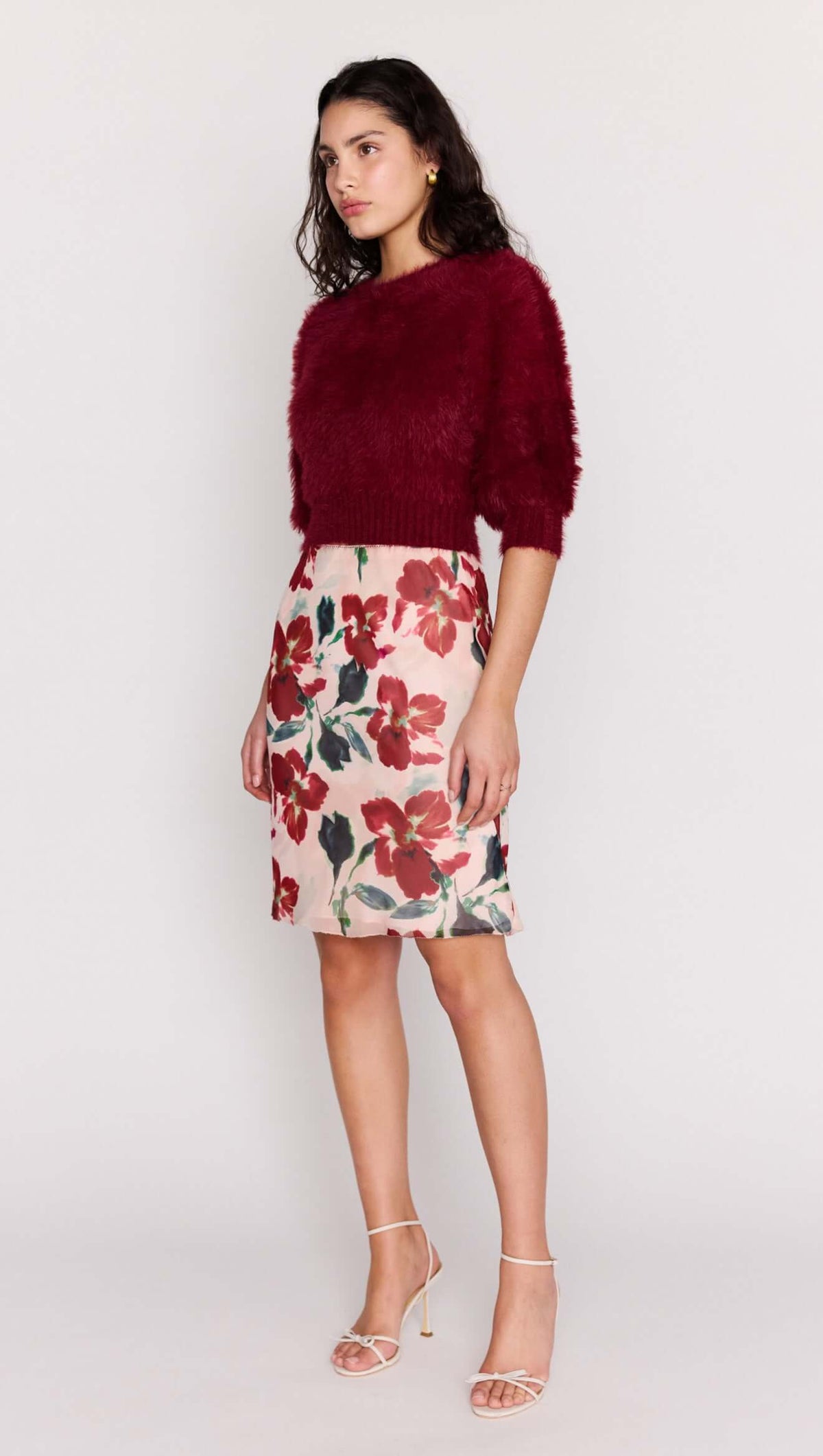 Model showcasing Burgundy Cropped Fluffy Knit Sweater paired with a floral skirt for a stylish look.