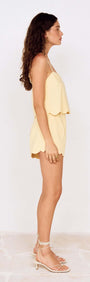 Model showcasing Butter Yellow Cotton Blend Scallop Hem Shorts from the side, highlighting the scallop hem design and summer styling.