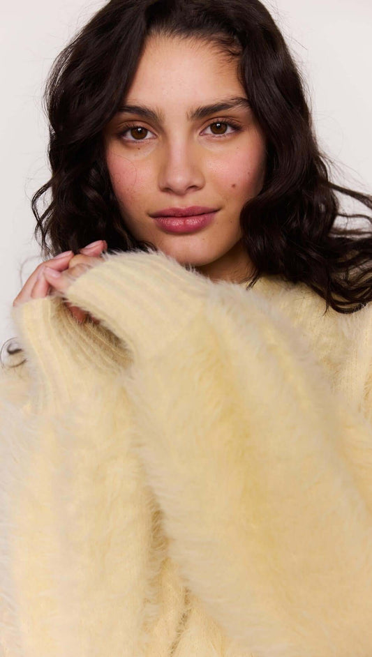Model wearing a Butter Yellow Fluffy Knit Jumper with long sleeves and a soft, fluffy texture.