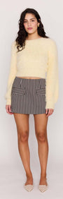 Model wearing a Butter Yellow Fluffy Knit Jumper paired with a striped skirt, showcasing a chic, relaxed look.