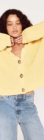 Butter Yellow Oversized Cardigan with Volume Sleeve worn by model, featuring button details and relaxed fit.