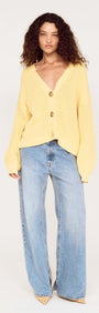 Model wearing a Butter Yellow Oversized Cardigan with Volume Sleeve paired with wide-leg jeans.