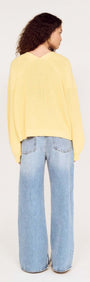 Butter Yellow Oversized Cardigan with Volume Sleeve worn with wide-leg jeans from the back view.