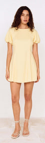 Butter Yellow Puff Sleeve Mini Dress showcased on a model, featuring soft fabric and a feminine silhouette.