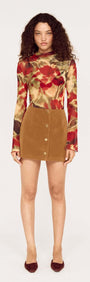 Model wearing a floral top and Button Front Faux Sude Mini Skirt showcasing a trendy fashion look.