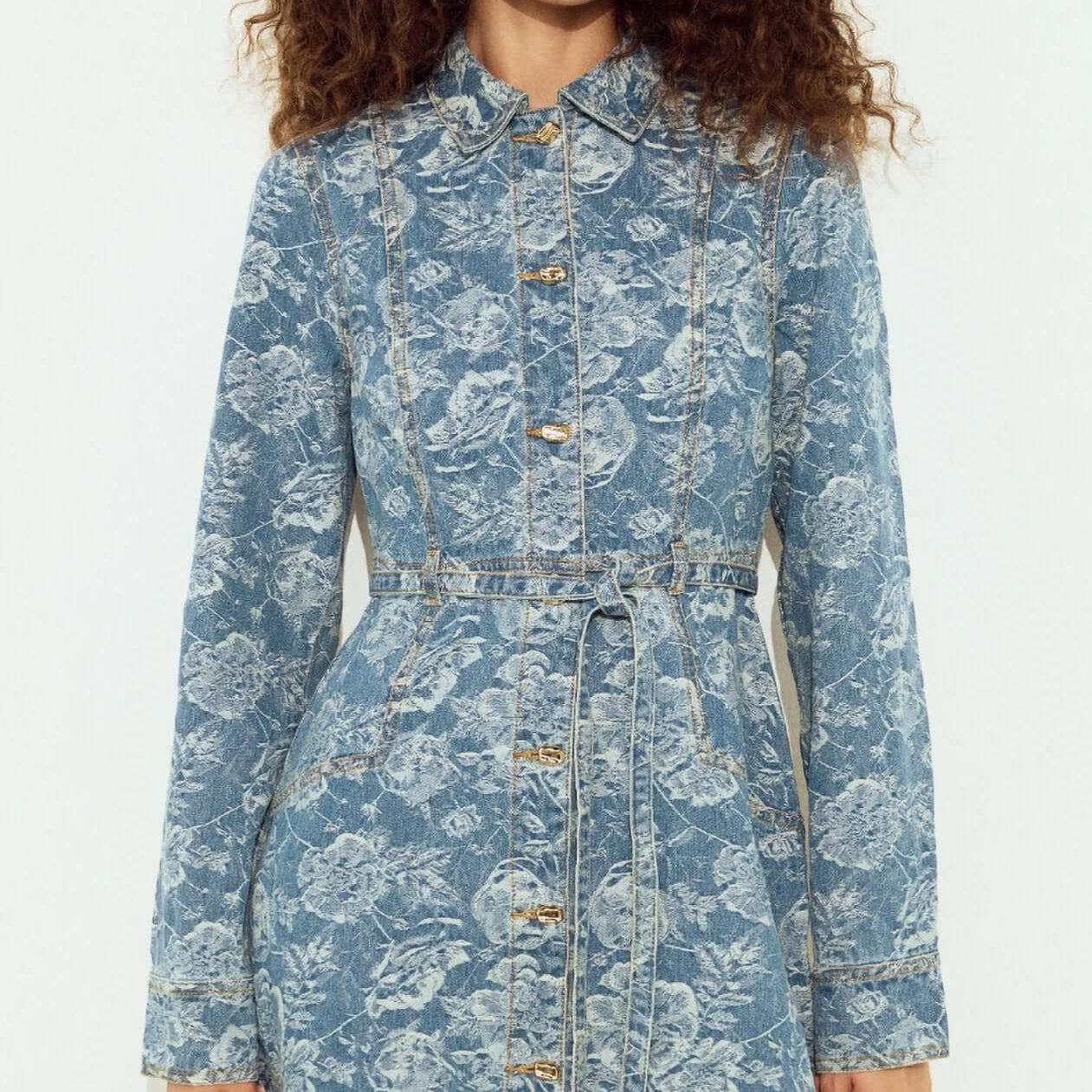 Button Through Floral Denim Dress with Tie Waist worn by model, featuring a floral print and button closure.