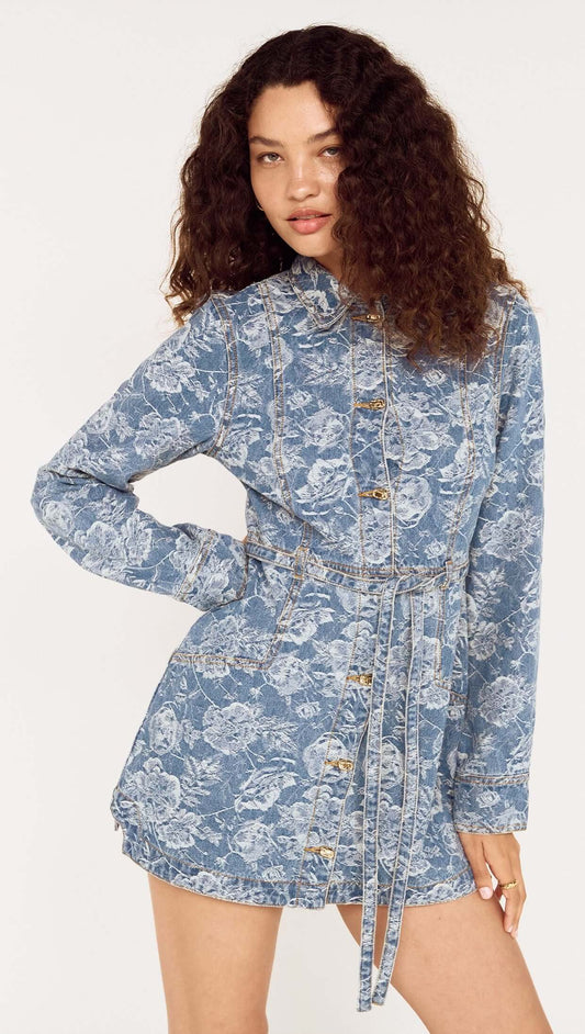 Button Through Floral Denim Dress with Tie Waist featuring a model wearing a stylish floral denim dress with button detail.