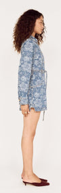 Side view of a model wearing a Button Through Floral Denim Dress with Tie Waist.