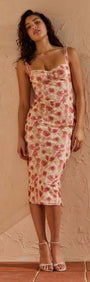 Pink Floral Bustier Mesh Midi Dress on model against textured wall, showcasing floral design and fitted silhouette.
