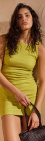 Chartreuse Ruched Mini Dress worn by model, highlighting sleek sleeveless silhouette and stylish shoulder ring detail.