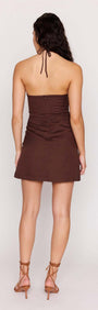 Back view of a model wearing the Chocolate Brown Linen Blend Halter Mini Dress with soft ruching and adjustable straps.