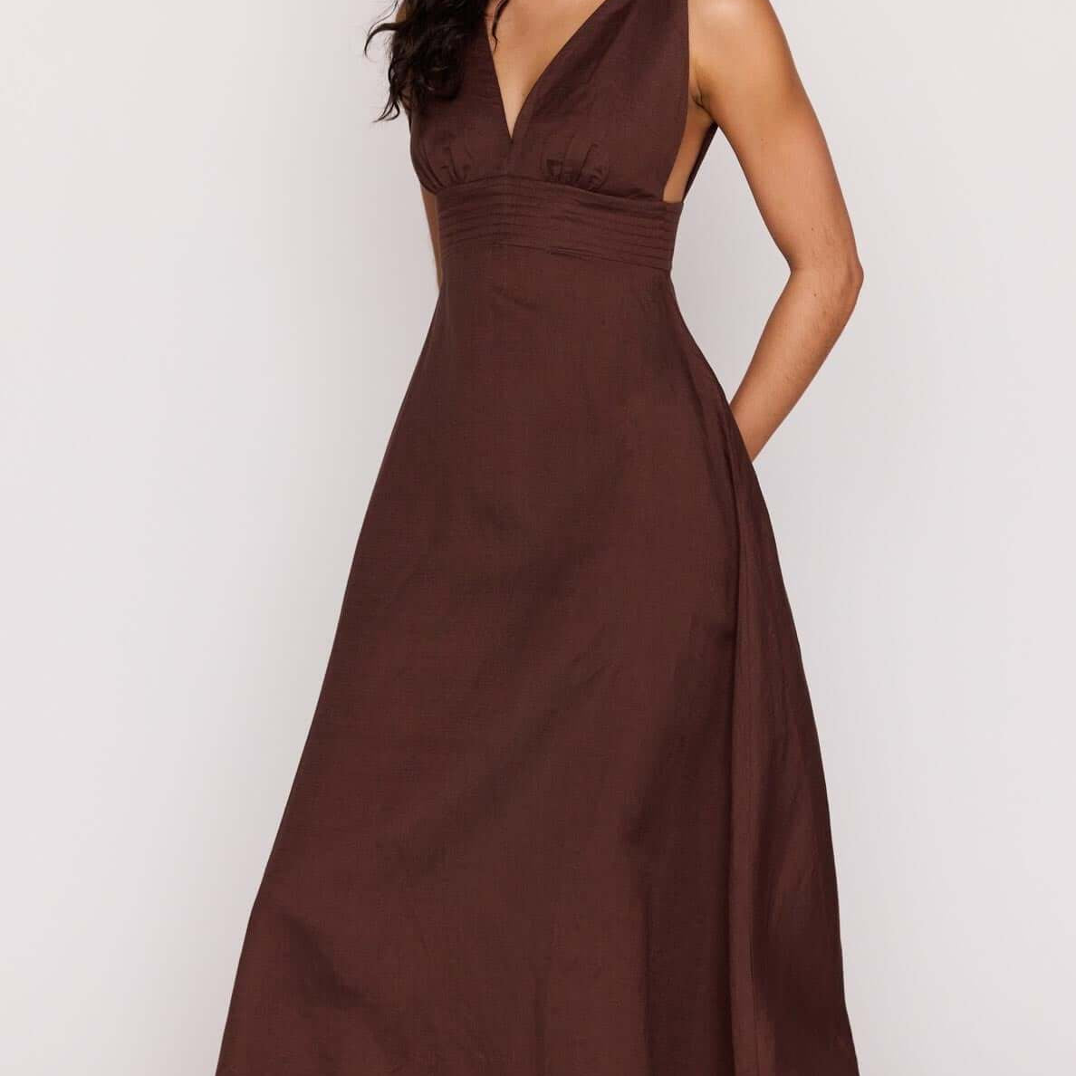 Chocolate Brown Linen Blend Maxi Dress worn by model, featuring a deep V neckline and a flowing design.