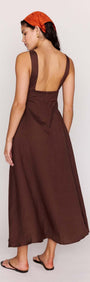 Model showcasing the back view of the Chocolate Brown Linen Blend Maxi Dress, featuring a deep V neckline and sleeveless design.