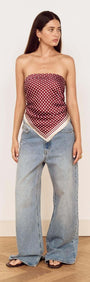 Model wearing a Chocolate Polka Dot Scarf styled as a bandeau top with wide-leg jeans.