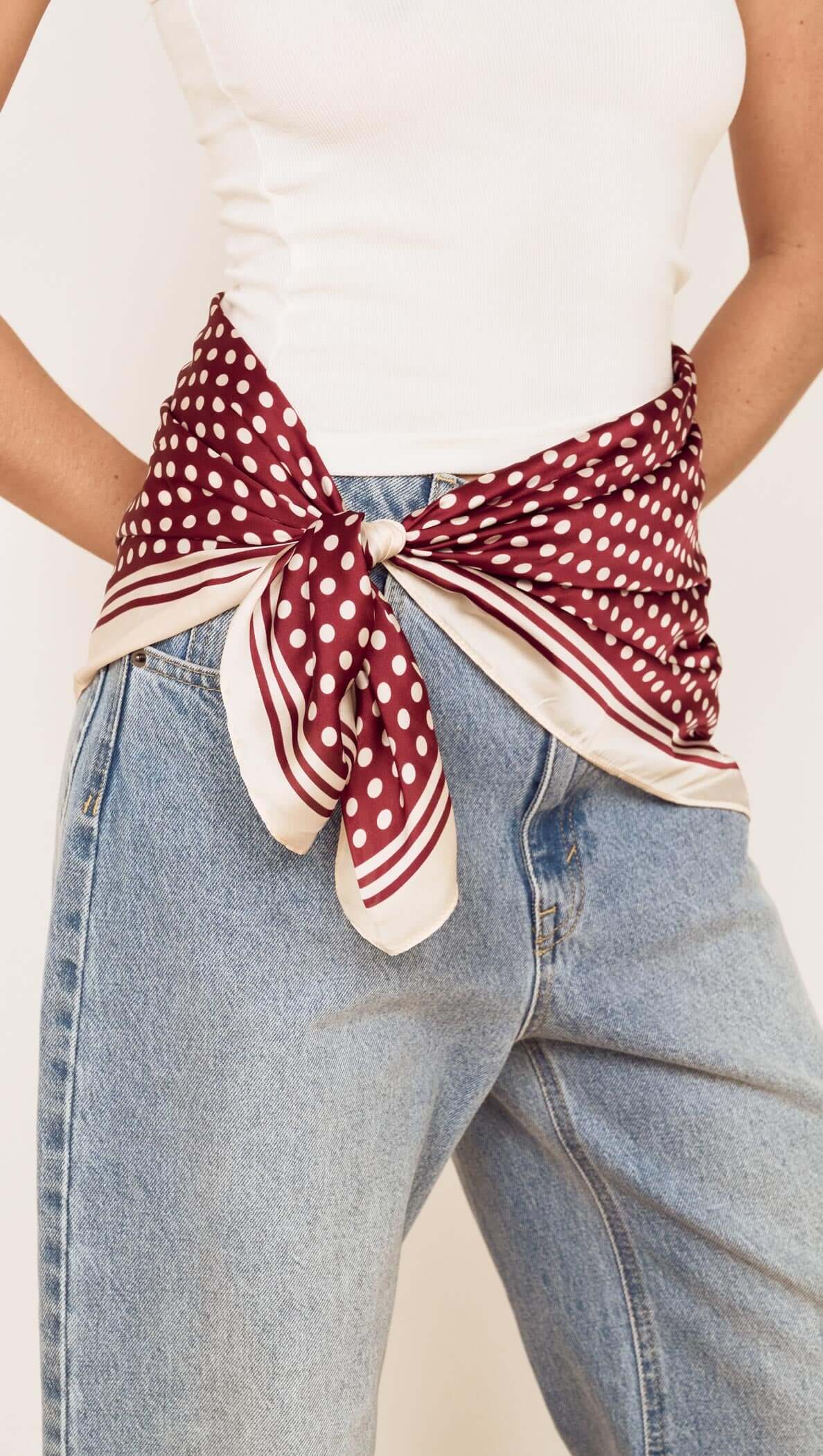 Chocolate Polka Dot Scarf styled as a waist wrap with denim, showcasing rich chocolate and classic polka dot pattern.