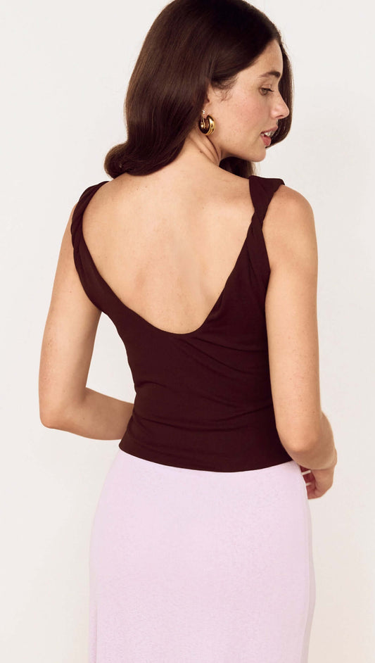 Woman wearing the Chocolate Twist Shoulder Mesh Top with a low scoop back and twist shoulder details.
