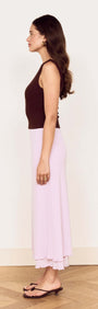 Model showcasing the elegant Chocolate Twist Shoulder Mesh Top with stylish pink skirt and brown sandals.