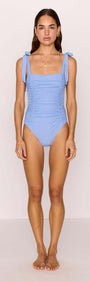 Model wearing a Blue Ruched One Piece Swimsuit with self-tie shoulder straps in cornflower blue