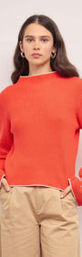 Coral Knit Top with Contrast Trim shown on a model, featuring flared cuffs and a relaxed fit.