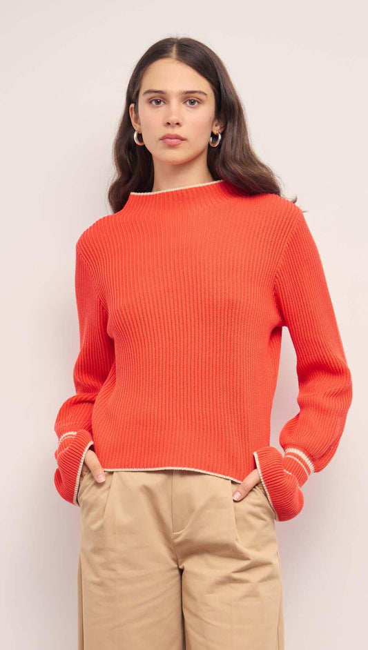 Coral Knit Top with Contrast Trim shown on a model, featuring flared cuffs and a relaxed fit.