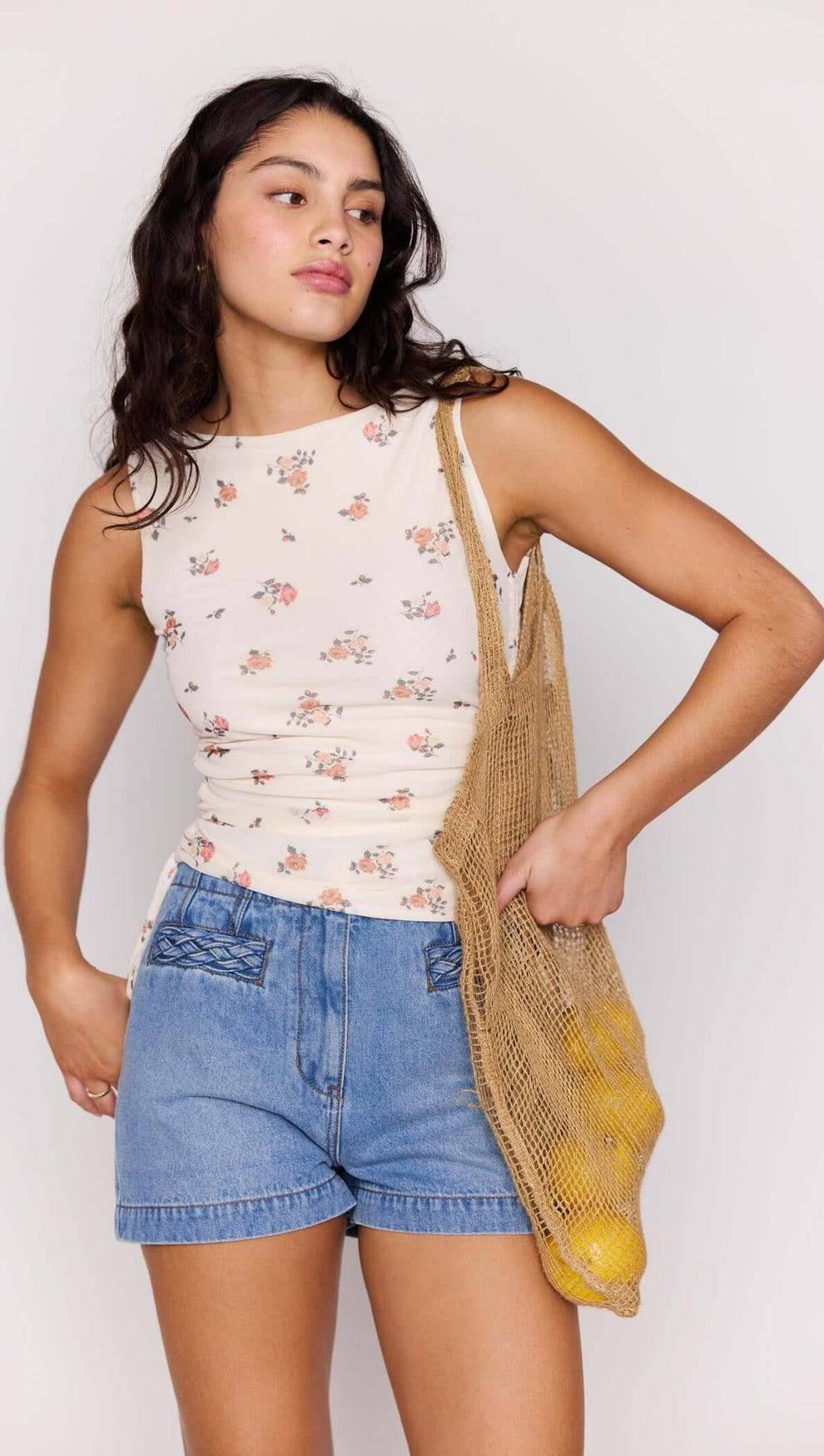 Cream Floral Boat Neck Mesh Top worn by a woman, paired with denim shorts and a woven bag.