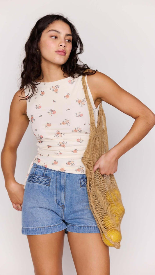 Cream Floral Boat Neck Mesh Top worn by a woman, paired with denim shorts and a woven bag.
