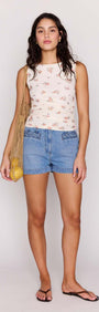 Model wearing the Cream Floral Boat Neck Mesh Top with denim shorts and a netted bag, ideal for casual summer styling.