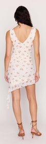 Back view of a model wearing a Cream Floral Ruffled Asymmetrical Mesh Mini Dress showcasing its stylish design.