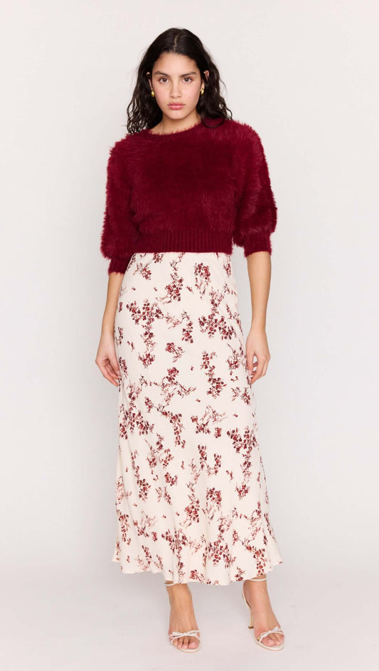 Model wearing a Cream Floral Toile Bias Cut Maxi Skirt paired with a burgundy sweater, showcasing a stylish and elegant outfit.