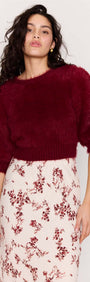 Model showcases the Cream Floral Toile Bias Cut Maxi Skirt paired with a cozy burgundy cropped sweater.