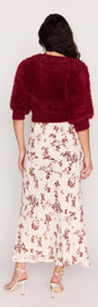 Model wearing a maroon fuzzy cropped sweater with the Cream Floral Toile Bias Cut Maxi Skirt, showcasing the back view.