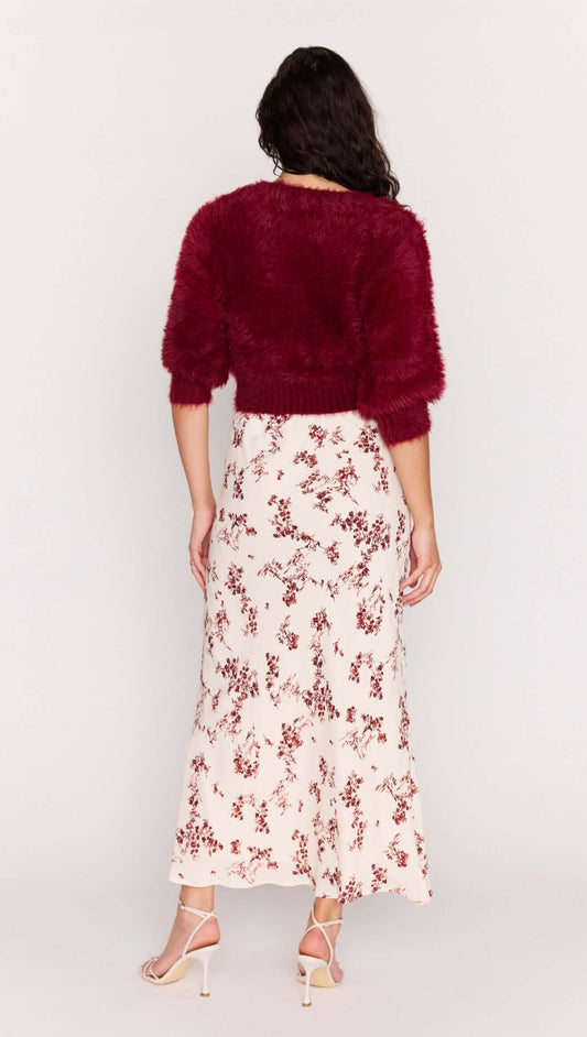 Model wearing a maroon fuzzy cropped sweater with the Cream Floral Toile Bias Cut Maxi Skirt, showcasing the back view.