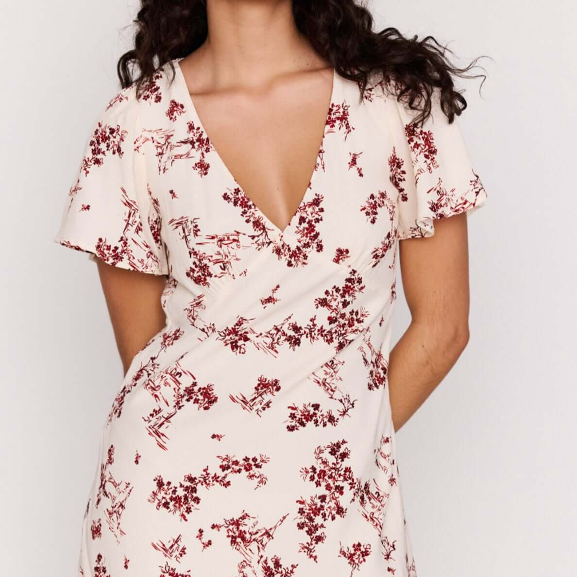 Cream Floral Toile Mini Dress with a plunging V neckline and flutter sleeves in a soft romantic design.