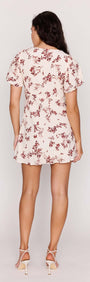 Back view of the Cream Floral Toile Mini Dress featuring flutter sleeves and a floral design.