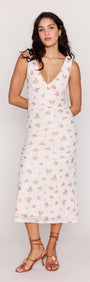 Cream Floral V-Neck Mesh Midi Dress modeled by a woman, showcasing the floral pattern and fitted silhouette.