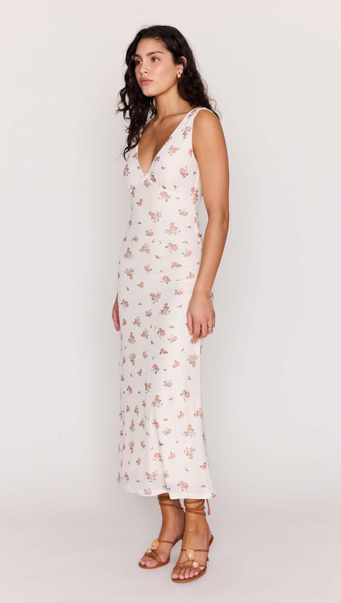 Cream Floral V-Neck Mesh Midi Dress displayed on a model, showcasing its flattering silhouette and floral design.
