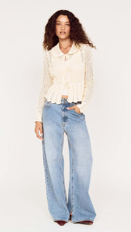 Model wearing a Cream Pointelle Knit Cardi with Tie Front styled with wide-leg jeans.