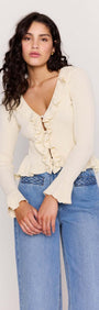 Model wearing the Cream Ruffled Cardigan, featuring a button-through front and cascading ruffle trim.