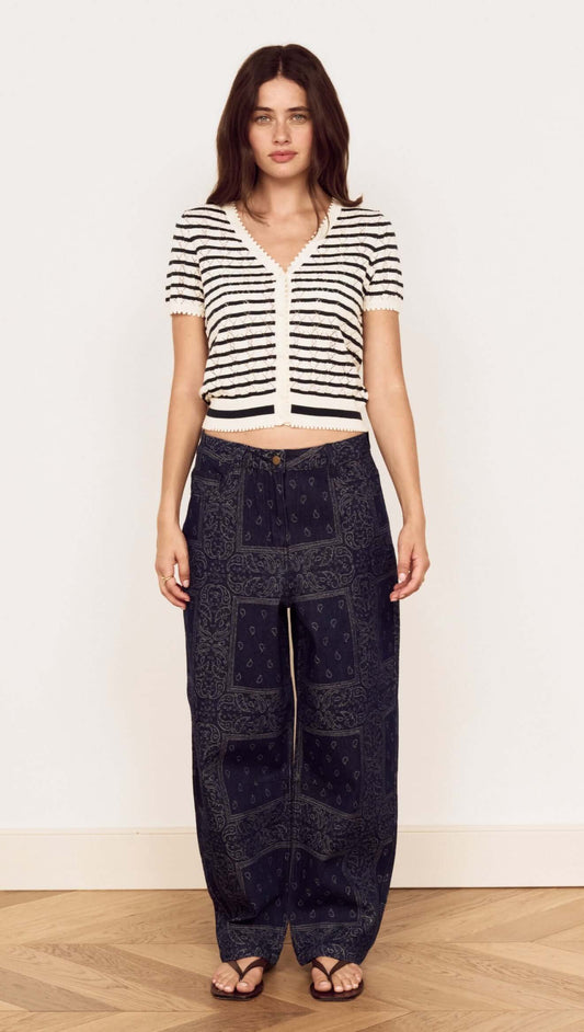 Model wearing the Cream Stripe Cotton Pointelle Knit Top with relaxed pants in a stylish pose.