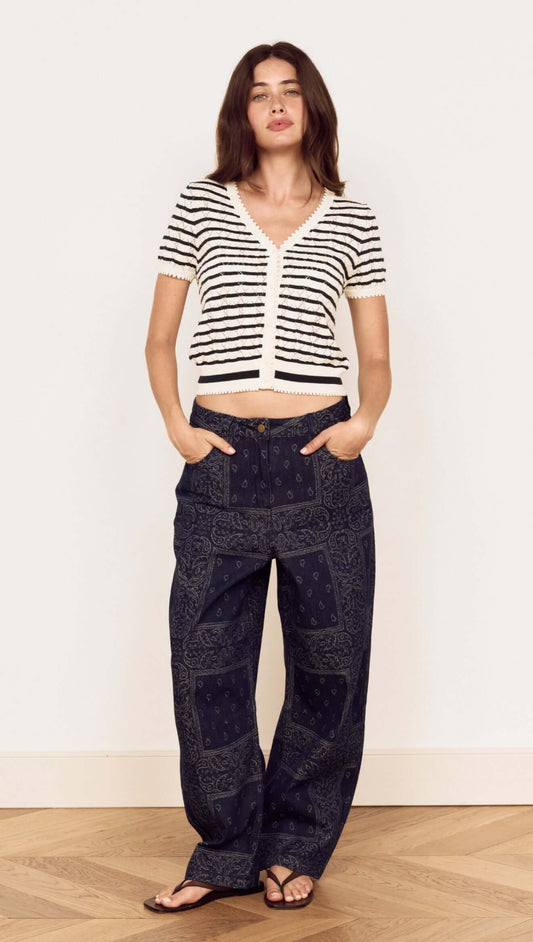 Model wearing the Cream Stripe Cotton Pointelle Knit Top with relaxed pants and sandals, showcasing an effortless look.