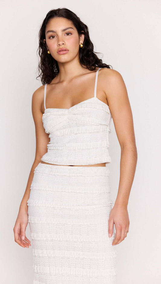 Model wearing the Cream Textured Lace Cropped Cami Top featuring slim straps and tiered lace detailing.